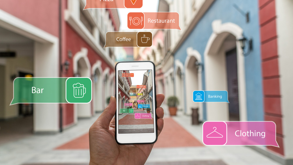 Dans la rue. Une main tient un smartphone.