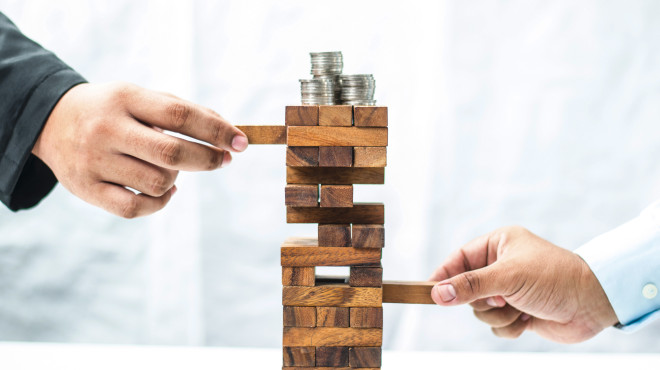 Geschicklichkeitsspiel Wackelturm mit Geld darauf  
