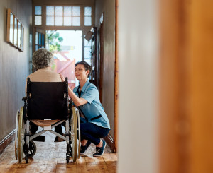 Pflegerin mit Seniorin im Rollstuhl